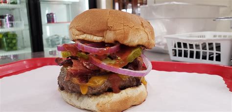 Wild willy's burgers - 3oz Angus Beef with cheese, lettuce, tomato, pickle, 1,000 island dressing on a potato bun. Cooked all the way through.